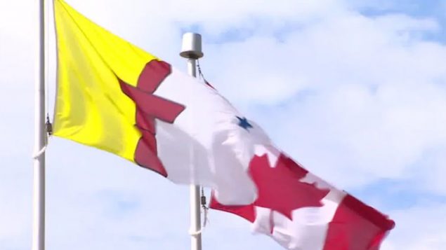 علم إقليم نونافوت (إلى اليسار) يرفرف إلى جانب العلم الكندي/Travis Burke/CBC/هيئة الاذاعة الكنديّة