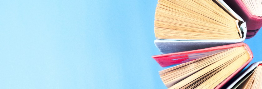 Top view of bright colorful hardback books in a circle.