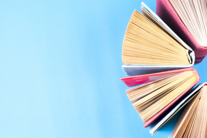 Top view of bright colorful hardback books in a circle.