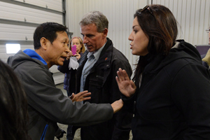 An RCMP officer looks on as Li Xue Jiang, of the People's Daily, China's largest newspaper, argues with Press Secretary to the Prime Minister Julie Vaux. (Photo: Sean Kilpatrick/CP)