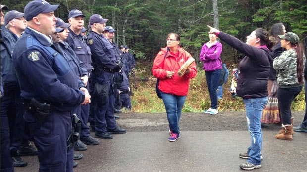 Elsipogtog First Nation Indigenous protesters face RCMP police officers. (Photo: CBC)