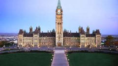 The Centre Block of Parliament as it appears today with the central Tower of Victory and Peace, more commonly known as the Peace Tower.which houses a carillon, clock, and the Books of Remembrance of Canada's was dead.