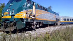 The locomotive of the crash near Ottawa pushed off the tracks and showing damage from the impact of the bus into it's side (photo-Transportation Safety Board) CLICK to ENLARGE