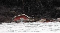 Rains caused a landslide in the Laurentian area north of Montreal Quebec, destroying 3 cottages and four boathouses, pushing them into the Lac des Seize Iles lake. (photo-CBC) CLICK to ENLARGE
