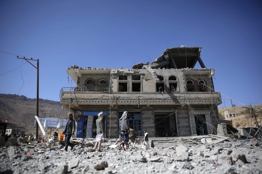 People gather at the site of a house damaged by Saudi-led airstrikes in Sanaa, Yemen, Monday, Jan. 4, 2016. According to U.N. figures, the war in Yemen has killed at least 5,884 people since March, when fighting escalated after the Saudi-led coalition began launching airstrikes targeting the Houthi rebels. (AP Photo/Hani Mohammed)