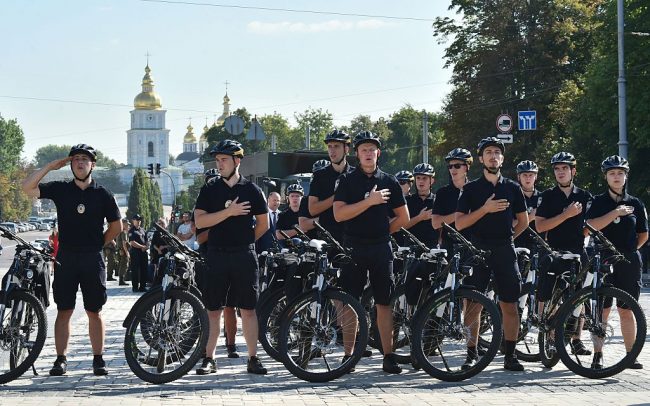 Police officers sing as they celebrate the first Ukrainian national police day in the center of Kiev on August 4, 2016. SERGEI SUPINSKY/AFP/Getty Images