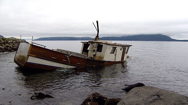 half sunk abandoned fishing boat.