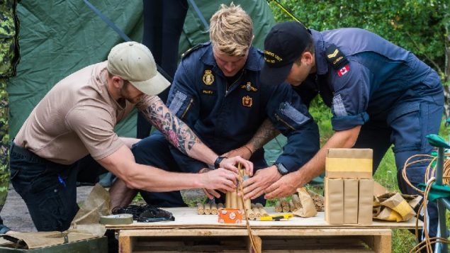 Canadian navy divers prepare explosives used to blow up old naval mines and other old ordnance in the Baltic