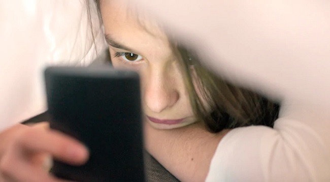 Girl looking at cell phone.