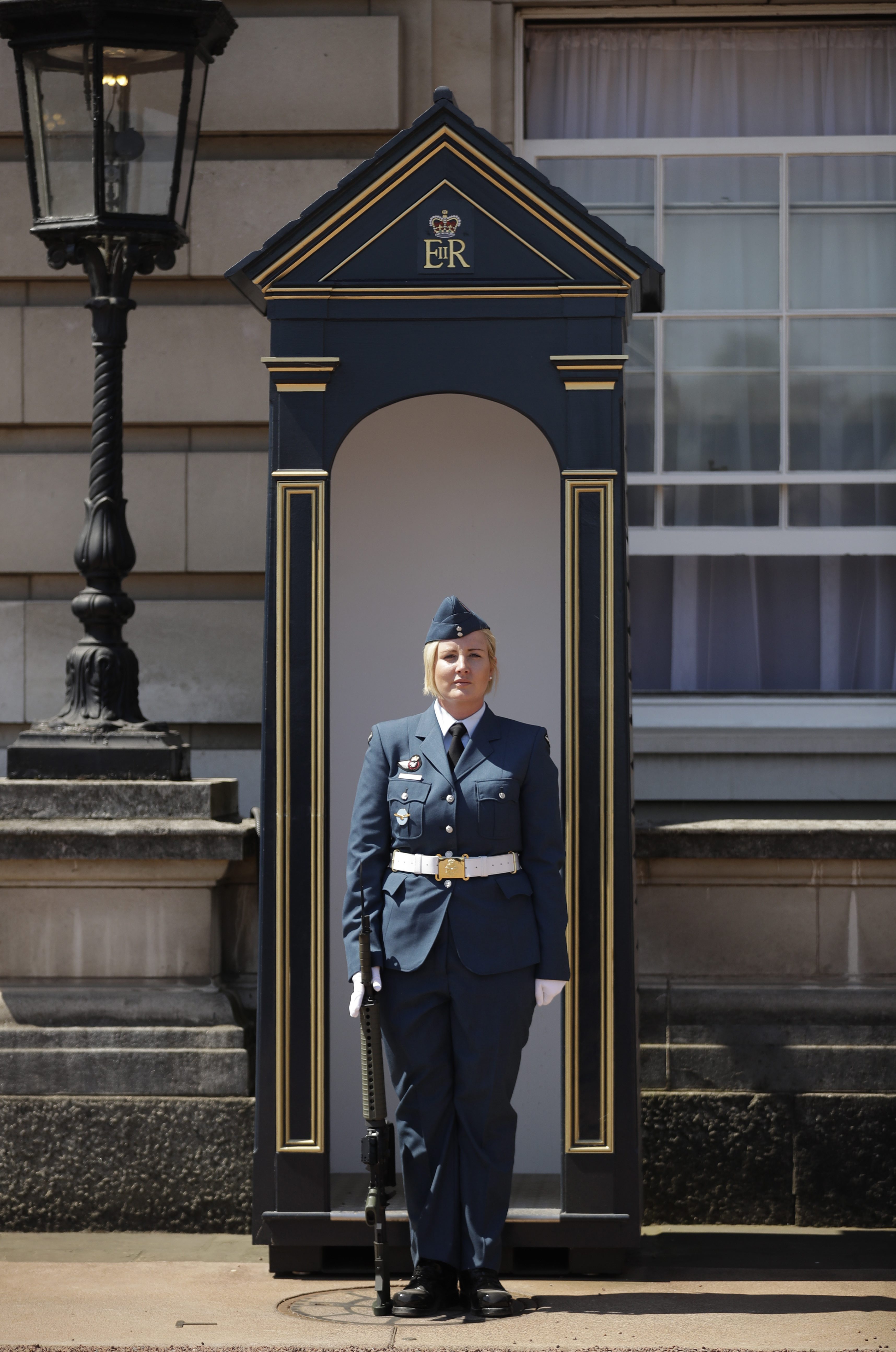 Female RCAF member in front of queen's guard post.