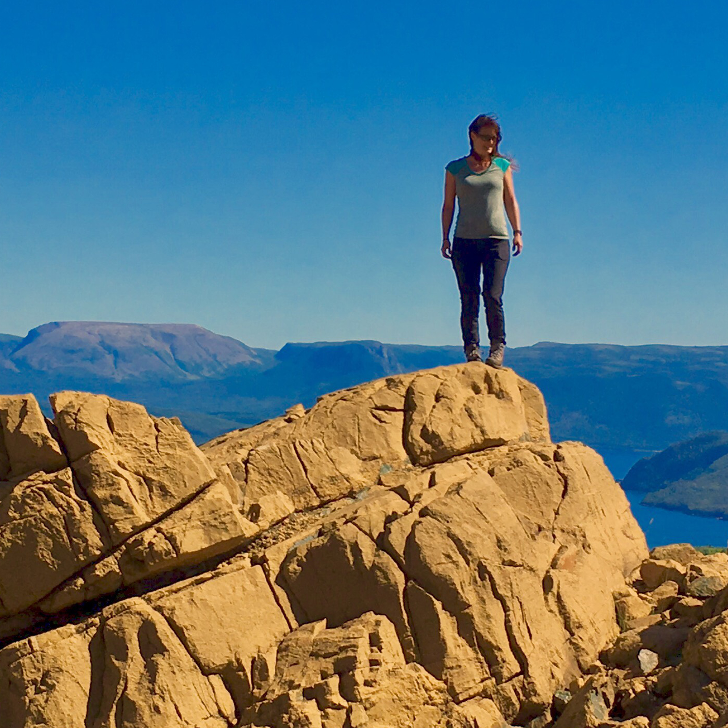 Nathalie Gauthier standing on a rocky outcrop.