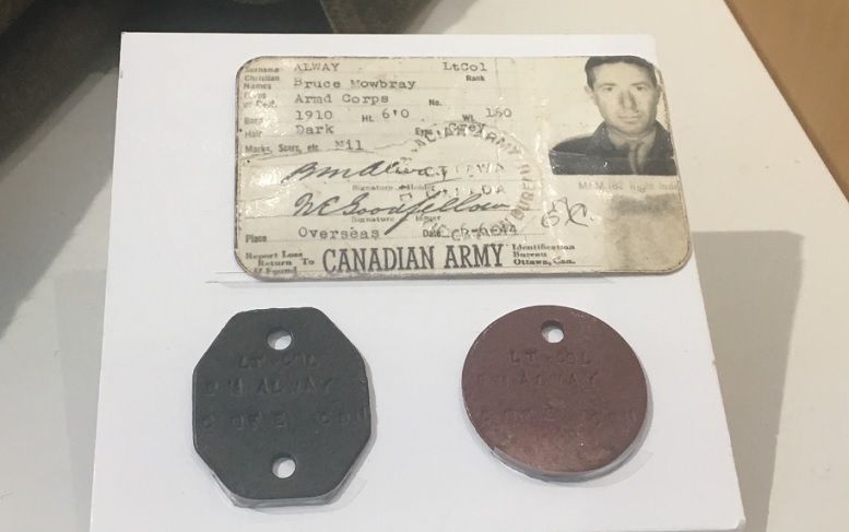 Actual Identity Discs and card. The discs would have been worn around the next on a cord, but most soldiers changed that to a leather shoelace. (Juno Beach Centre)