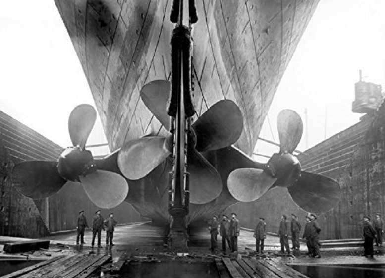 The huge propellers of Titanic. shown compared to workers beneath them . (Harland and Wolff)