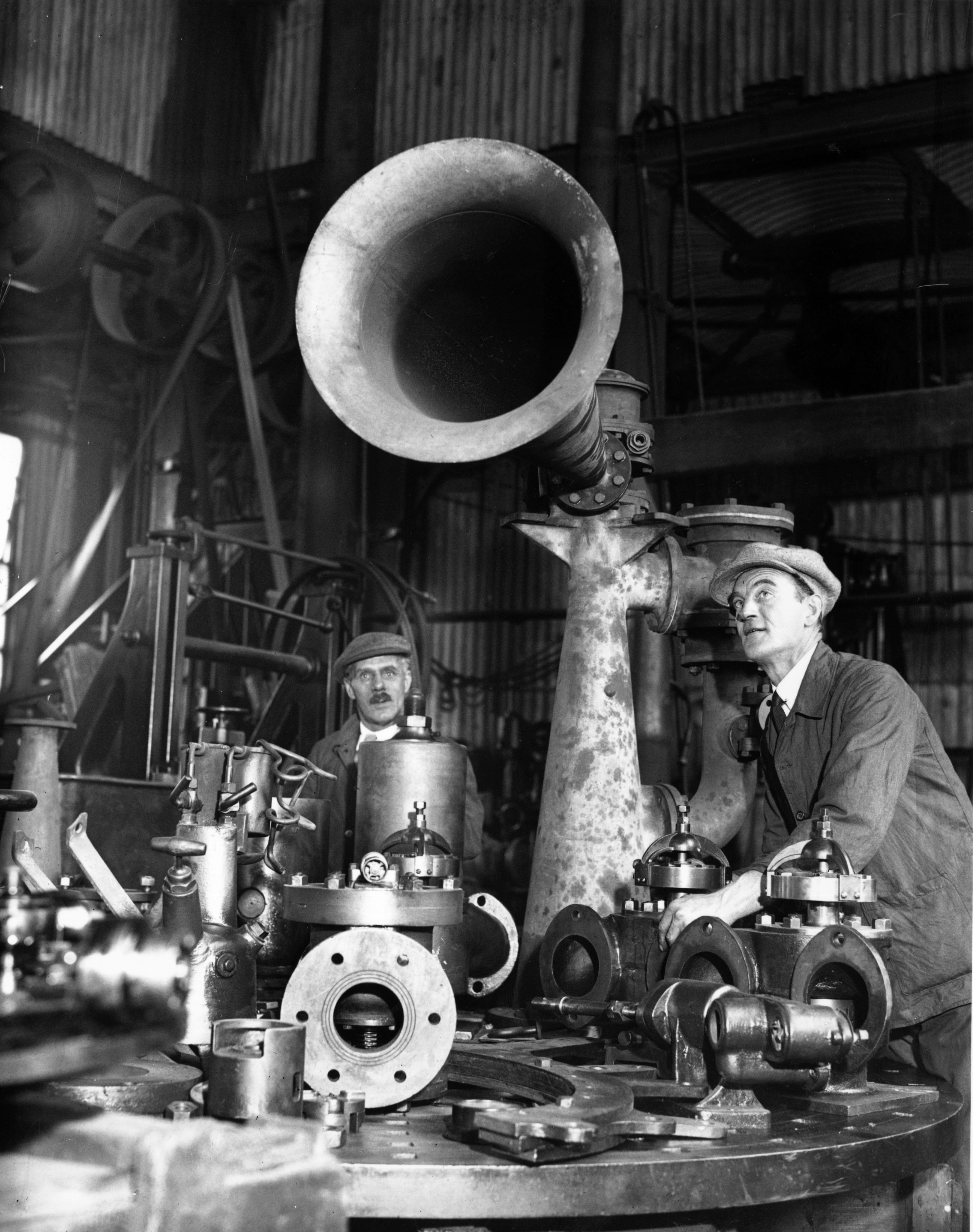 19th October 1936: A workman adjusting a foghorn for coastal use at Trinity House's depot, Blackwall. (Photo by Harry Todd/Fox Photos/Getty Images)