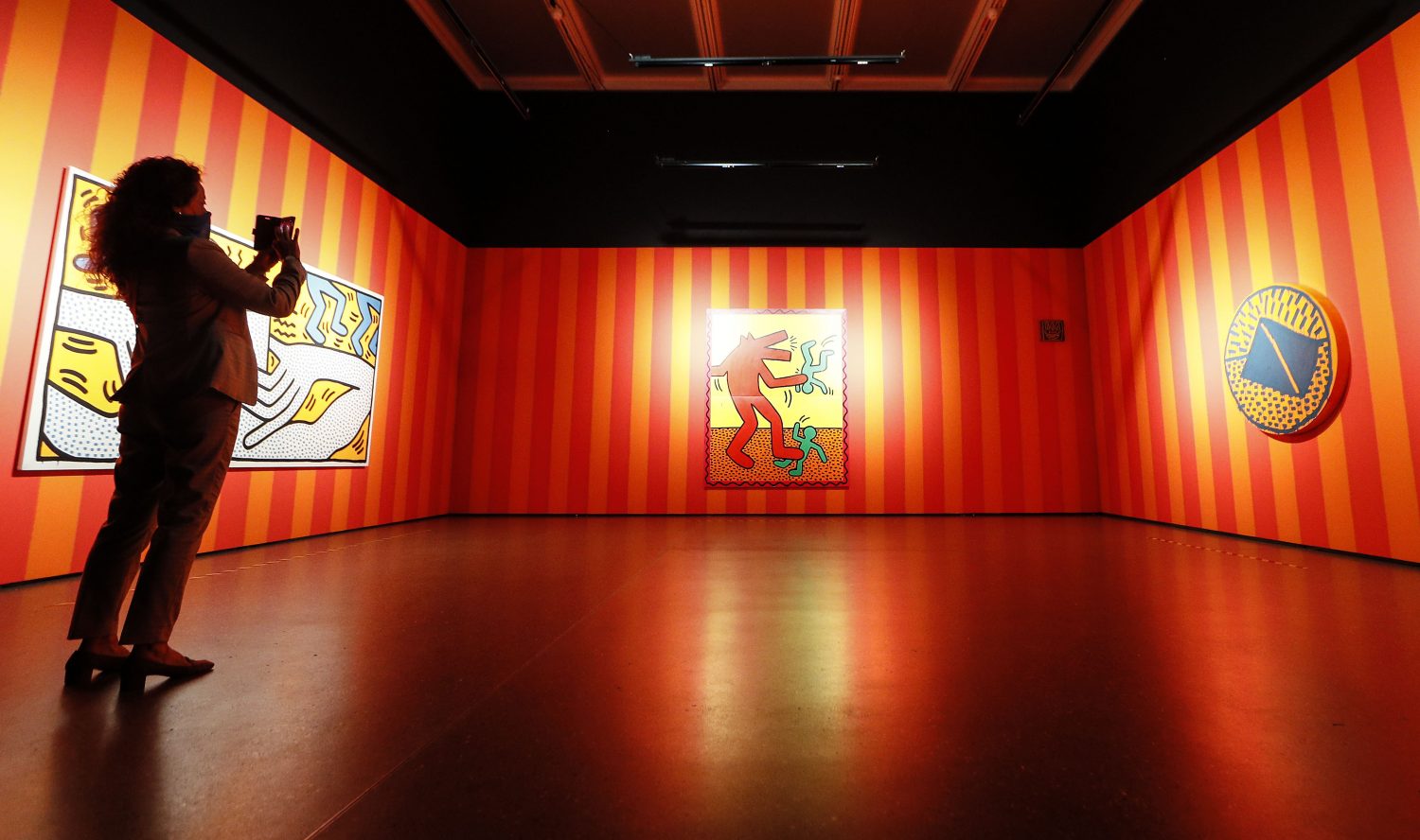 Visitors watching artwork by US artist Keith Haring at the