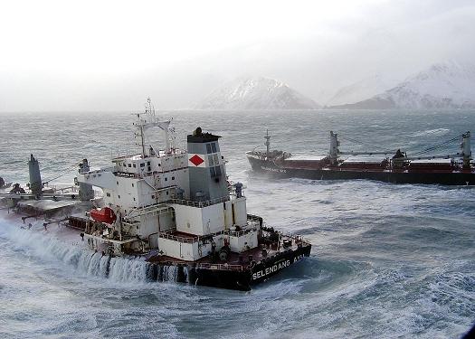 The two halves of the Malaysian cargo ship Selendang Ayu are pounded by waves as it sits offshore of Skan Bay on Unalaska Island near Unalaska, Alaska, in the Aleutian Island chain Saturday, 11 December, 2004. AFP PHOTO/HO/US Coast Guard 