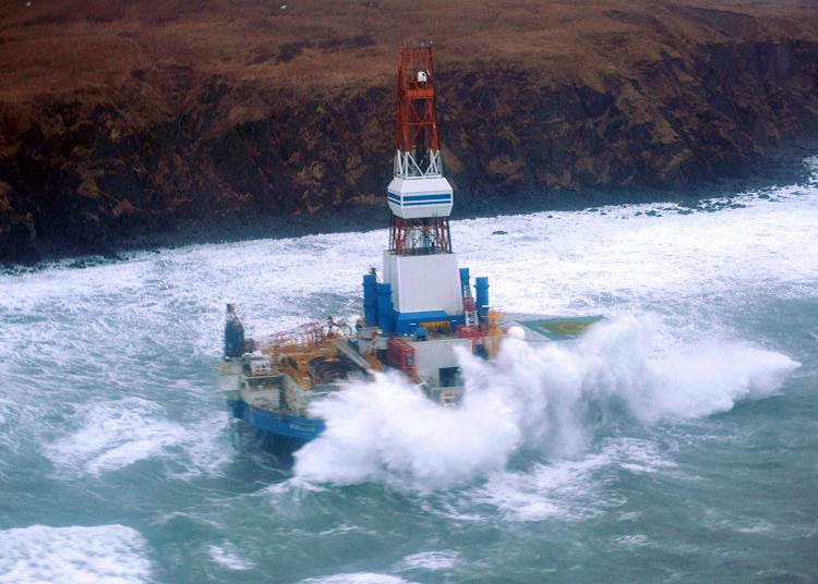 This image provided by the US Coast Guard, shows the conical mobile drilling unit Kulluk owned by Royal Dutch Shell agroundaground on the southeast side of Sitkalidak Island, Alaska, January 1, 2013. AFP PHOTO/HANDOUT / US Coast Guard / Petty Officer 3rd Class Jonathan Klingenberg