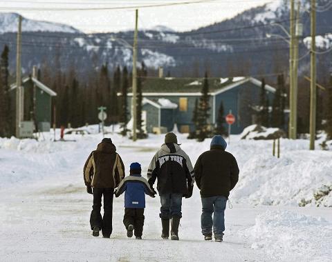 Residents walk in the northern Labrador community of Natuashish. Photo: Andrew Vaughan, The Canaian Press.