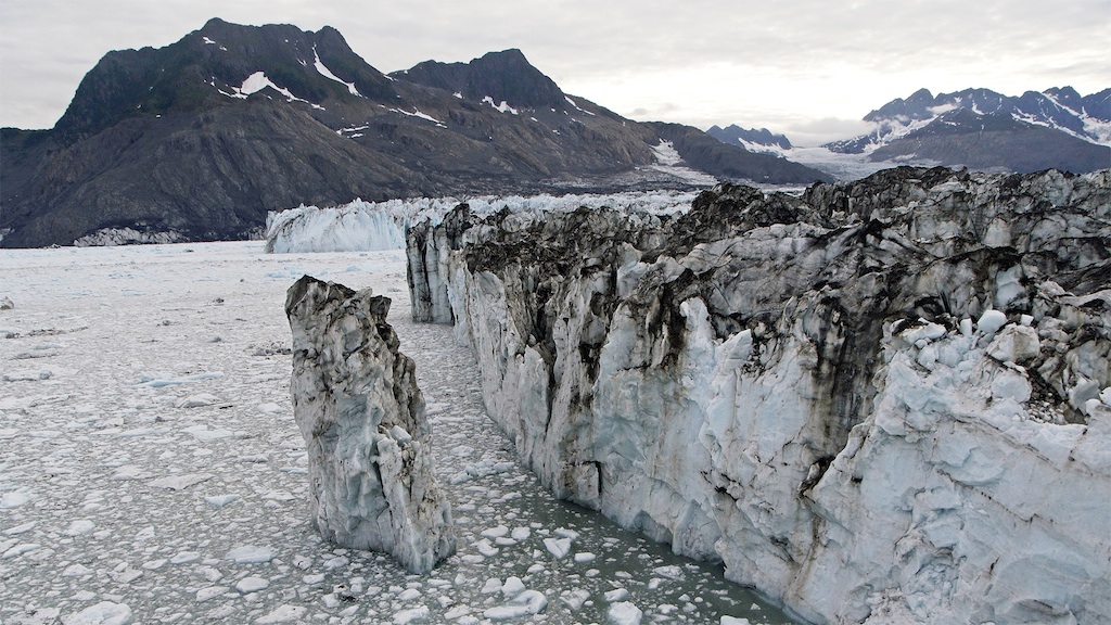 Standing 100 feet above the bay, a tower of ice in the process of becoming an iceberg separates from Columbia Glacier's terminus. NASA/U.S. Army photo. Courtesy Alaska Dispatch.