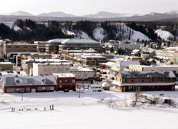 The city of Whitehorse, surrounded by mountains, sits on the banks of the Yukon River. One of the projects cited in the housing report is the collaboration between the Tr'ondek Hwech'in First Nation, Canada Mortgage and Housing Corporation, Yukon Housing Corporation, and Han Construction Limited. (Chuck Stoody/The Canadian Press)