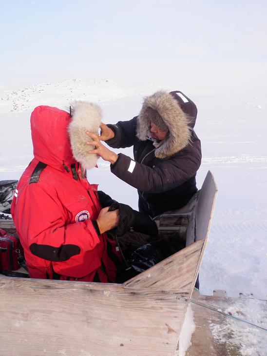 Jaypootie checks Arctic gear of Eye on the Arctic cameraman Alfonse Mondello. Photo by Eilís Quinn. 