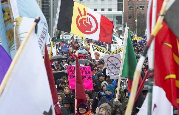 Idle No More protesters listen to speakers during a rally on Parliament Hill Friday January 11, 2013 in Ottawa, Canada. THE CANADIAN PRESS/Adrian Wyld