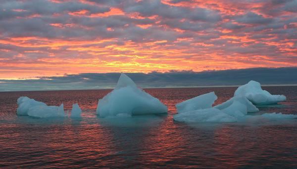 Ice chunks floats in the Arctic Ocean as the sun sets near Barrow, Alaska. AP Photo/Arctic Sounder, Beth Ipsen