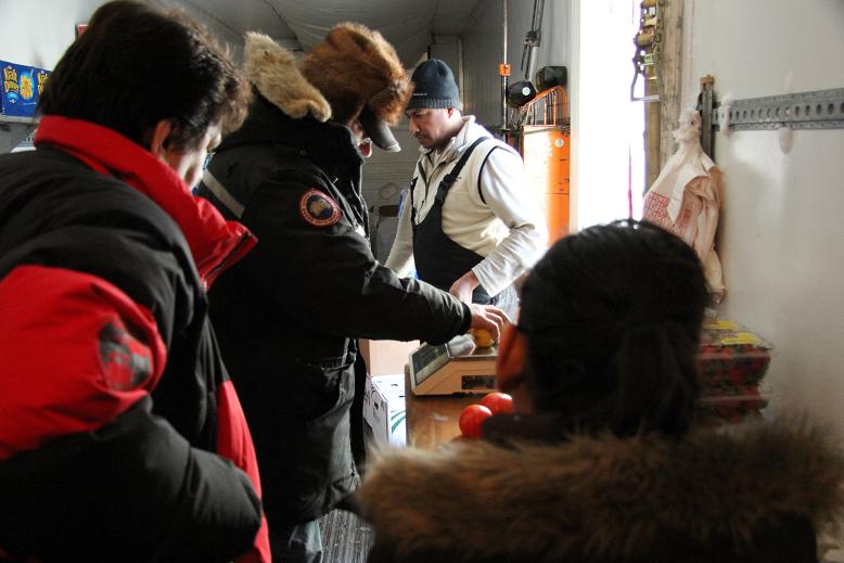 Bill Rutherford helping customers inside his mobile produce trailer. Photo: Eilís Quinn