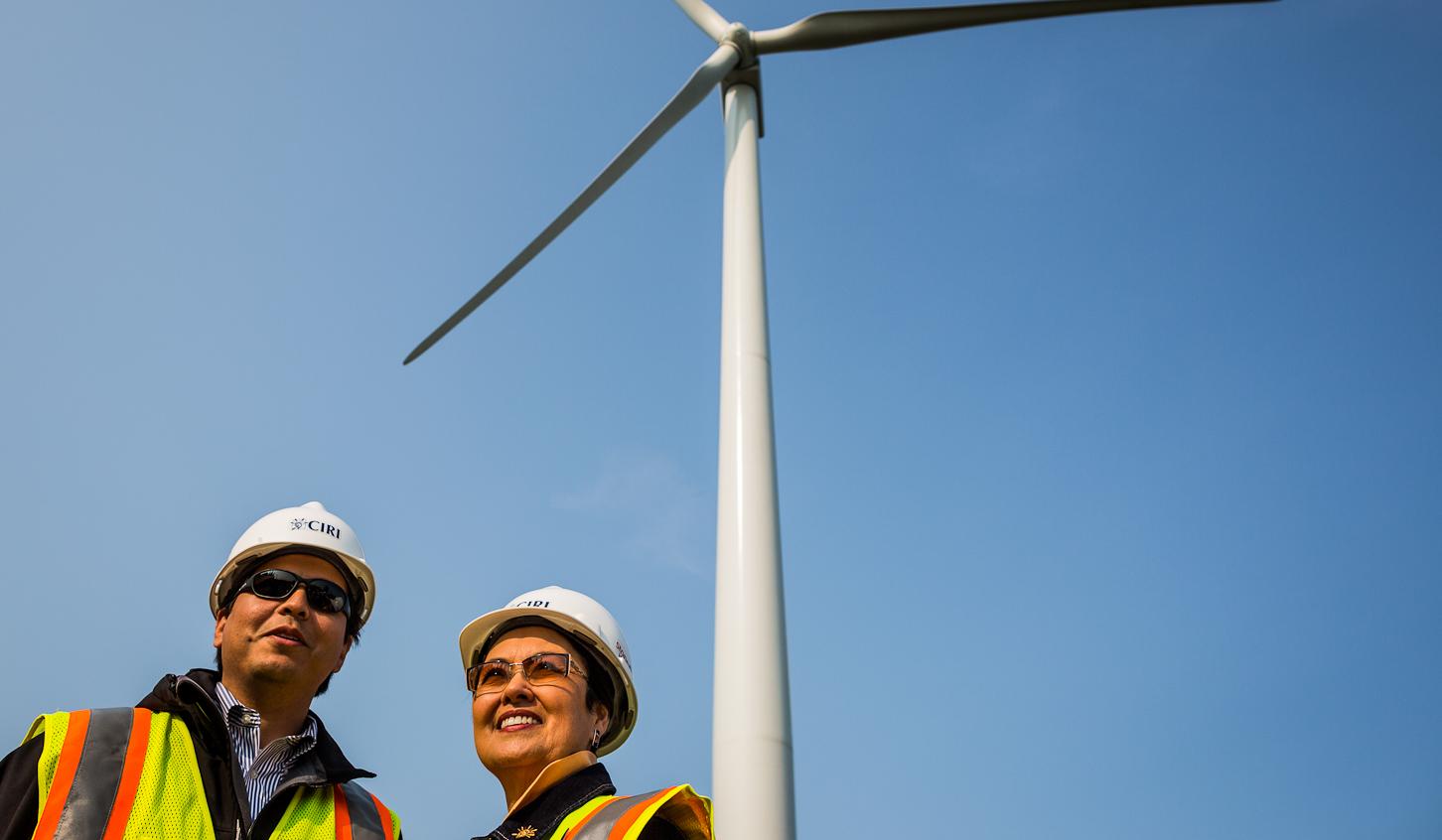 CIRI president and CEO Margie Brown, right, and senior vice president Ethan Schutt in front of the first fully erected wind turbine on Fire Island. July 18, 2012. Photo: Loren Holmes.