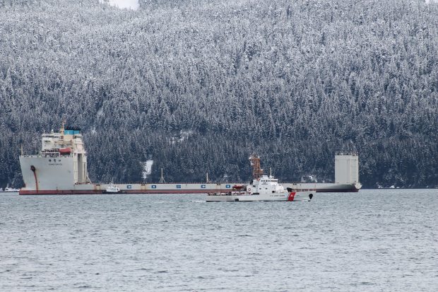 The 708-foot-long Xiang Yun Kou arrived in Seward, Alaska on Feb. 28, 2013, to dry-haul the Noble Discoverer to port in Asia. Pictured in the foreground is the Coast Guard cutter Mustang. Jackie Wilde photo. Alaska Dispatch. 