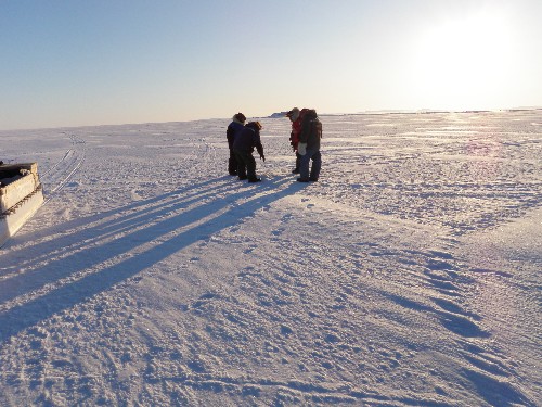 Clyde River hunters Elijah, Joe and Maurice explain seal holes to us. Photo: Eilis Quinn