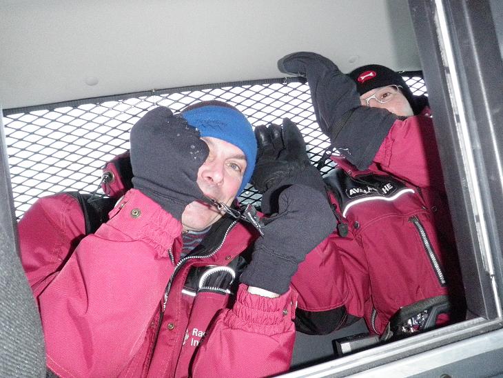 Jean and Luc riding in back of RCMP truck. Photo: Eilis Quinn