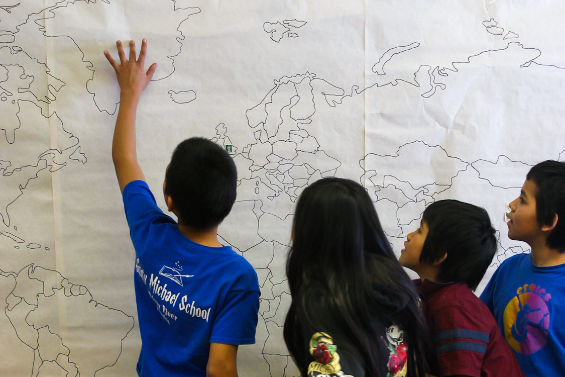 Stony River's Gusty Michael students identify spots on a world map in the lower grades (pre-kindergarten to seventh grade) classrooms. Alex DeMarban photo 