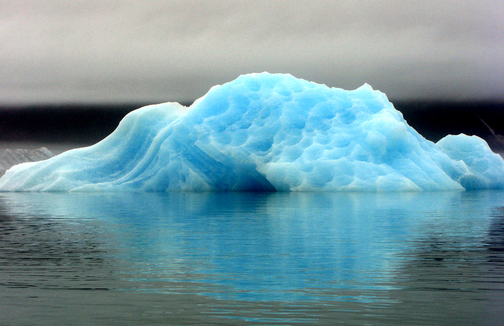 Icebergs floating in Bear Glacier Lake give off an eery, luminous neon blue. One can easily kayak up to this iceberg, which is massive enough to be considered stable. (Eric Adams / Alaska Dispatch)