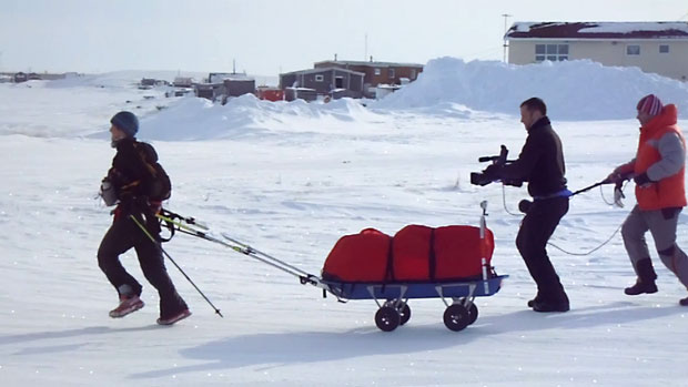 Lowri Morgan, left, is followed by a Welsh TV crew as she runs towards the 6633 Extreme Ultra's finish line in Tuktoyaktuk, N.W.T., on Friday afternoon. ((Submitted by Kevin Terpstra and Kim Taylor))