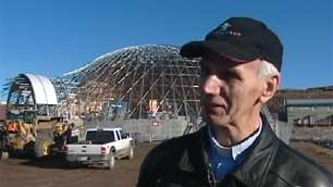 Rev. Brian Burrows, standing near the construction site of the new St. Jude's Anglican Cathedral, said the recent $500,000 donation is a 'sign that perhaps the faith is justified.' (CBC)
