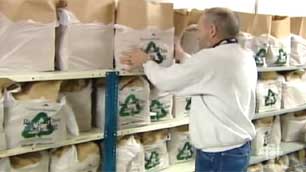 Dave Ritchie stocks shelves of food hampers at the Yellowknife Food Bank. (CBC)