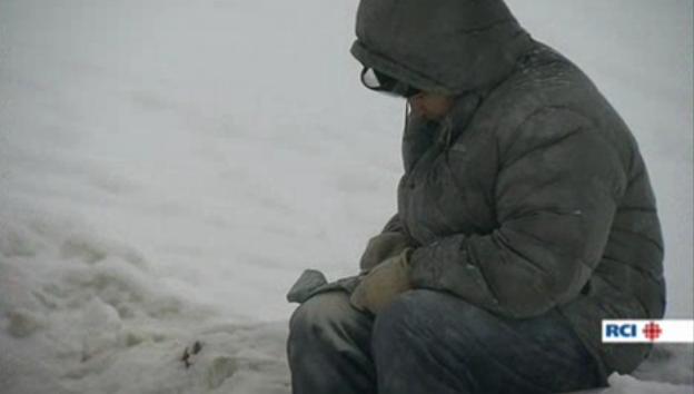 Artist working on stone carving outside in Cape Dorset, Nunavut. Image: Radio Canada International