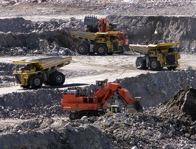 Heavy haulers and excavators work in the Diavik diamond mine pit on Lac de Gras, approximately 300km northeast of Yellowknife, NT Saturday July 19, 2003. (CP PHOTO/Adrian Wyld)