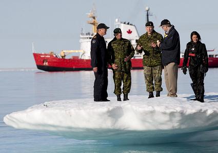 Prime Minister Stephen Harper, second from right, stands on an iceberg as he talks with Chief of the Defence Staff General Walter Natynczyk (centre) as they take part in a training exercise during Operation Nanook in Resolute, Nunavut on the third day of his five-day northern tour to Canada's Arctic on Wednesday Aug. 25, 2010. Photo: THE CANADIAN PRESS/Sean Kilpatrick