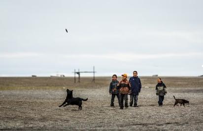 Kids playing with dogs in the St. Lawrence island village of Gambell. August 29, 2012. Photo: Loren Holmes. Alaska Dispatch. 
