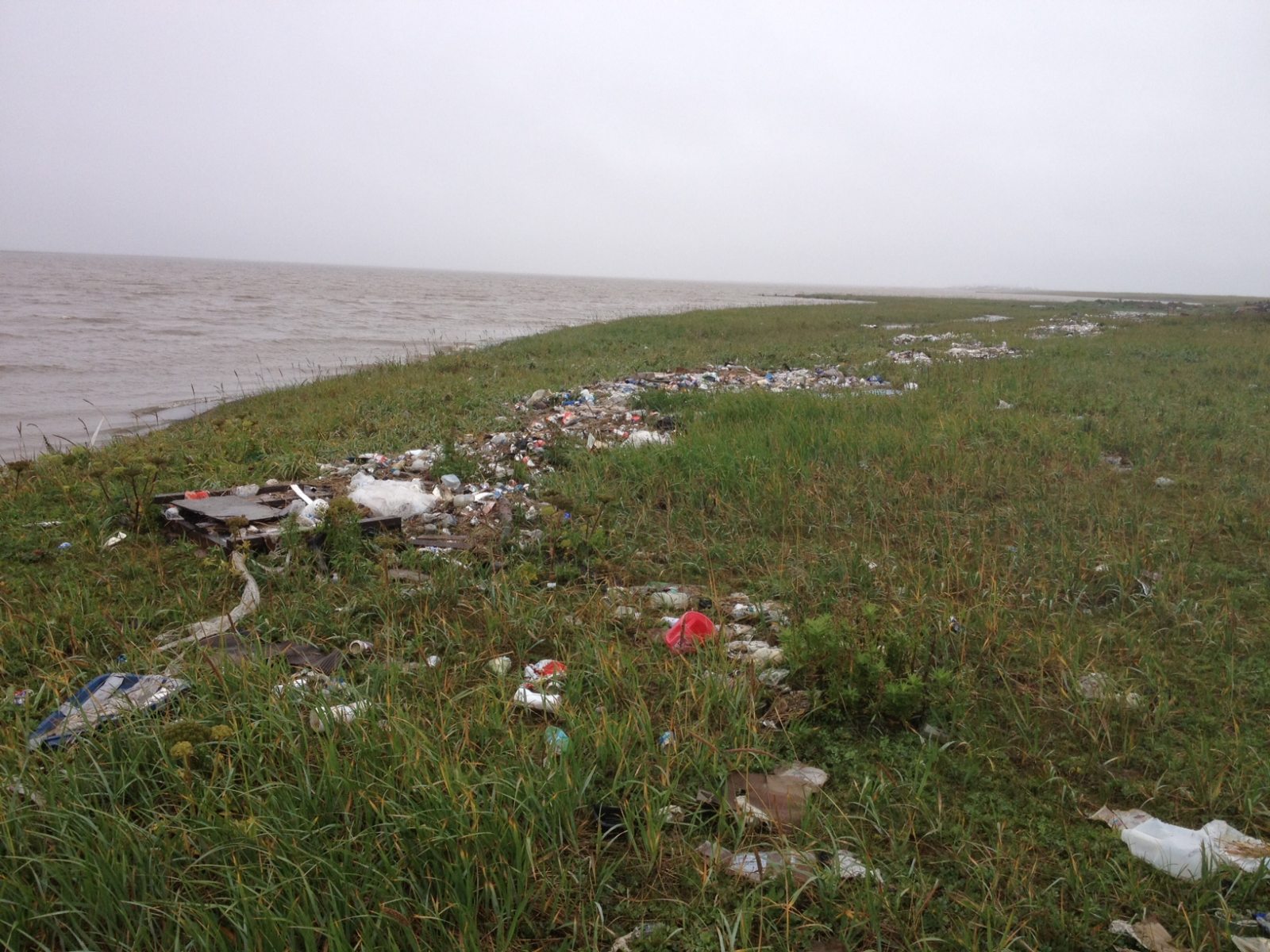 Trash from the Kivalina landfill displaced by flooding in August 2012. Photo: Austin Swan. Alaska Dispatch.