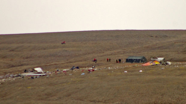 Authorities work at the scene of the First Air crash site in Resolute Bay, Nunavut. Twelve people were killed when Flight 6560 went down on Aug. 20, 2011. Photo Nicolas Laffont, Canadian Press.