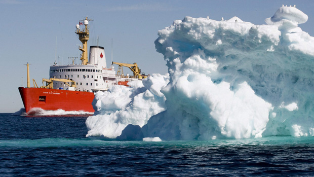 The Canadian Coast Guard icebreaker Louis S. St-Laurent sails past an iceberg in Lancaster Sound on July 11, 2008. (Jonathan Hayward/Canadian Press)