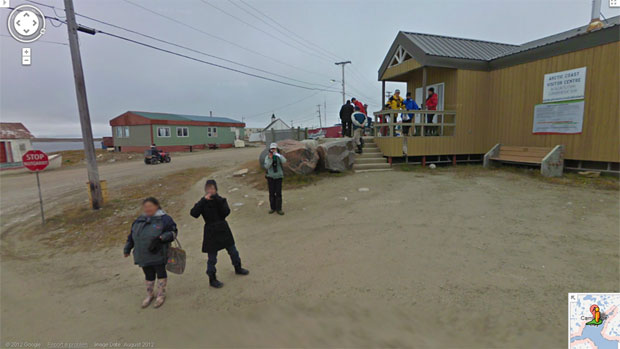 A group of people outside the visitor's centre in Cambridge Bay took photos of the Street View tricycle as it went by. (Google Maps) CBC.ca
