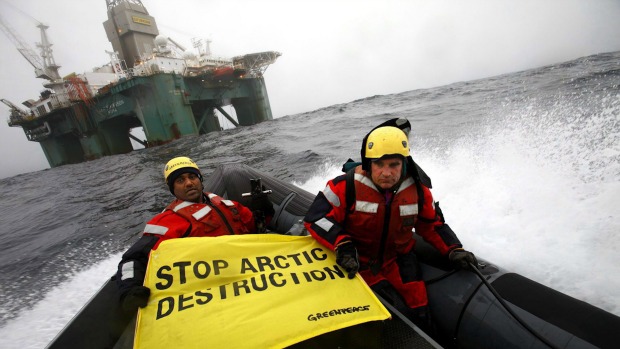 Greenpeace members hold a banner aboard a boat near an oil rig in the Davis Strait, off Greenland's west coast, Friday, June 17, 2011. (Greenpeace International, Jiri Rezac/The Canadian Press/AP)