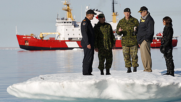 Canadian prime minister Stephen Harper talks with Gen. Walt Natynczyk, centre, while standing on an iceberg in Allen Bay in Resolute, Nunavut, in 2010. In the background is the Canadian Coast Guard icebreaker Henry Larsen. Photo Reuters.