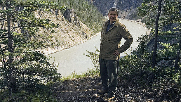 Prime Minister Stephen Harper stands by the Nahanni River in Nahanni National Park Reserve, Northwest Territories, during a trip in 2007. Harper is set to announce a new reserve or park along the river during his latest visit. (Fred Chartrand/Canadian Press)