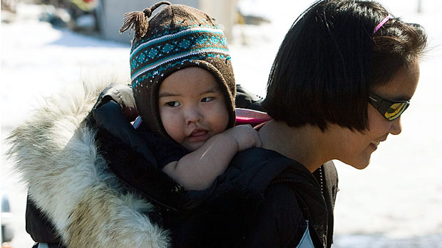 An Inuit woman and her child pictured in 2009 in Nunavut. Pauktuutit Inuit Women of Canada said Monday it is upset about the loss of funding from Health Canada, and it will mean projects on maternal and newborn care, family planning and other health issues are now threatened. (Sean Kilpatrick/Canadian Press)