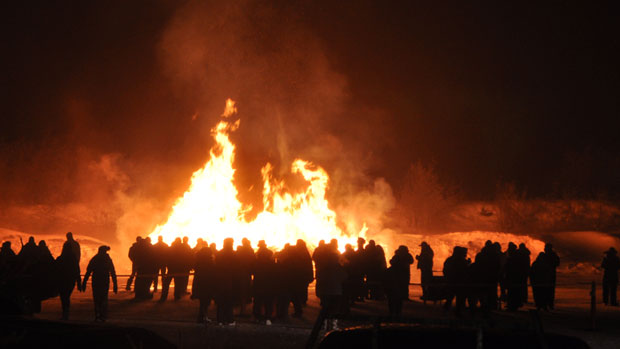 People gathered around a large bonfire in the community Saturday night. (Allison Devereaux/CBC)